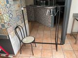 a chair and a table in a room with tiled walls