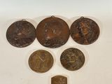 several different types of coins are displayed on a white surface