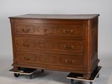 an image of a wooden chest of drawers on casteors