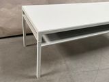 a white coffee table with a shelf underneath it