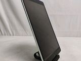 a tablet that is sitting on a stand on a table