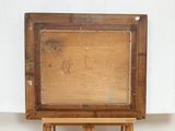 an old wooden easel with a painting on top of it