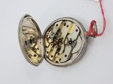 a silver pocket watch with a red string around it
