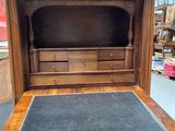 an old wooden desk with a chalk board on top of it