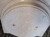 a close up of a microwave on a carpeted floor