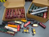 two boxes of toy trains sitting on a table