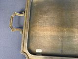 an antique brass tray with handles and handles on a blue background