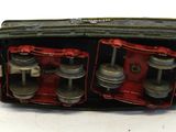 a small black and red box that has a bunch of silver objects inside of it
