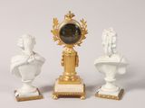 two statues of a man and a woman sitting on a pedestal