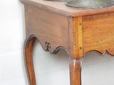 a small wooden table with a bowl on top of it