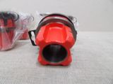 a red blow dryer sitting on a table next to a plastic bag