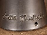 a silver bell with a name engraved on it