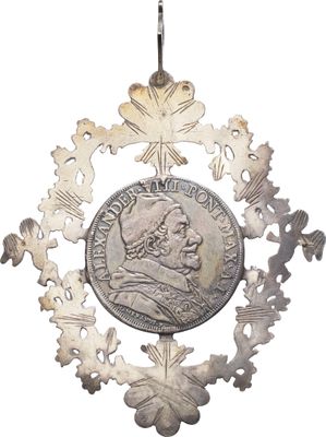 an image of a silver coin hanging from a silver chain