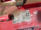 a close up of a red machine with a label on it
