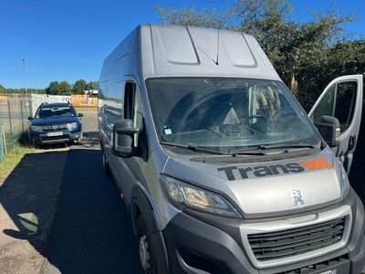 the grey van is parked next to the white van