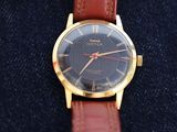 an image of a close up of a watch with a brown strap