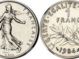 a coin with the image of a woman in a dress on it