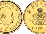 a close up of a gold coin with a crown on it
