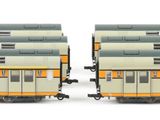 two trains that are sitting side by side on the tracks