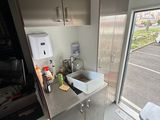 a kitchen with a sink and a toilet in it