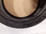 a close up of a tire on a white surface