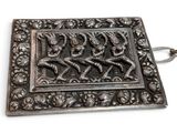 an image of a silver plate with a picture of a man and woman on horseback