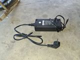 an image of a car charger on the ground next to a bicycle