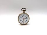 une petite montre de poche en or dont le cadran est orné de chiffres romains