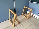two wooden folding chairs in the corner of a room