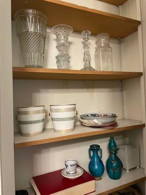 many dishes and glasses on the shelves in the kitchen