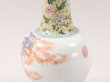a vase that is sitting on a stand on a white surface
