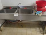 two sinks in the kitchen with a red bucket on the counter