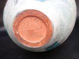 a close up of a vase on a table