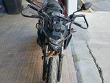 a motorcycle that is parked in front of a garage