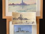 two watercolor paintings of a city and a lake in a wooden frame