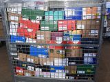 a metal cart with many boxes on it in a warehouse