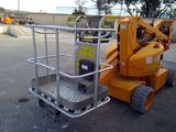a picture of a small orange scissor parked in a parking lot