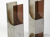 pair of silver and brown glass bookends on a white surface