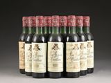six bottles of red wine are lined up in a row