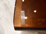a close up of a brown case with a logo on it