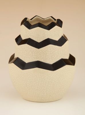 un vase blanc orné de rayures noires
