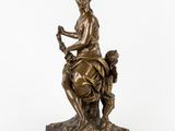 a bronze statue of a woman sitting on a horse