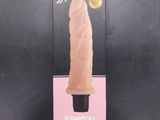an image of a pink sex toy in a package on a black surface