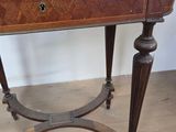a small wooden table with a drawer on top of it