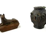 two vases with animals on them sitting next to each other