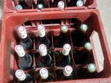 many bottles of beer in a red crate on the floor
