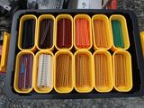 a tray that has many different colored beads in it