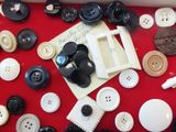 many different types of buttons on a red table