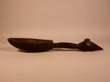 a wooden spoon with a handle on a white surface