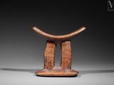 an image of a wooden stool with a curved seat